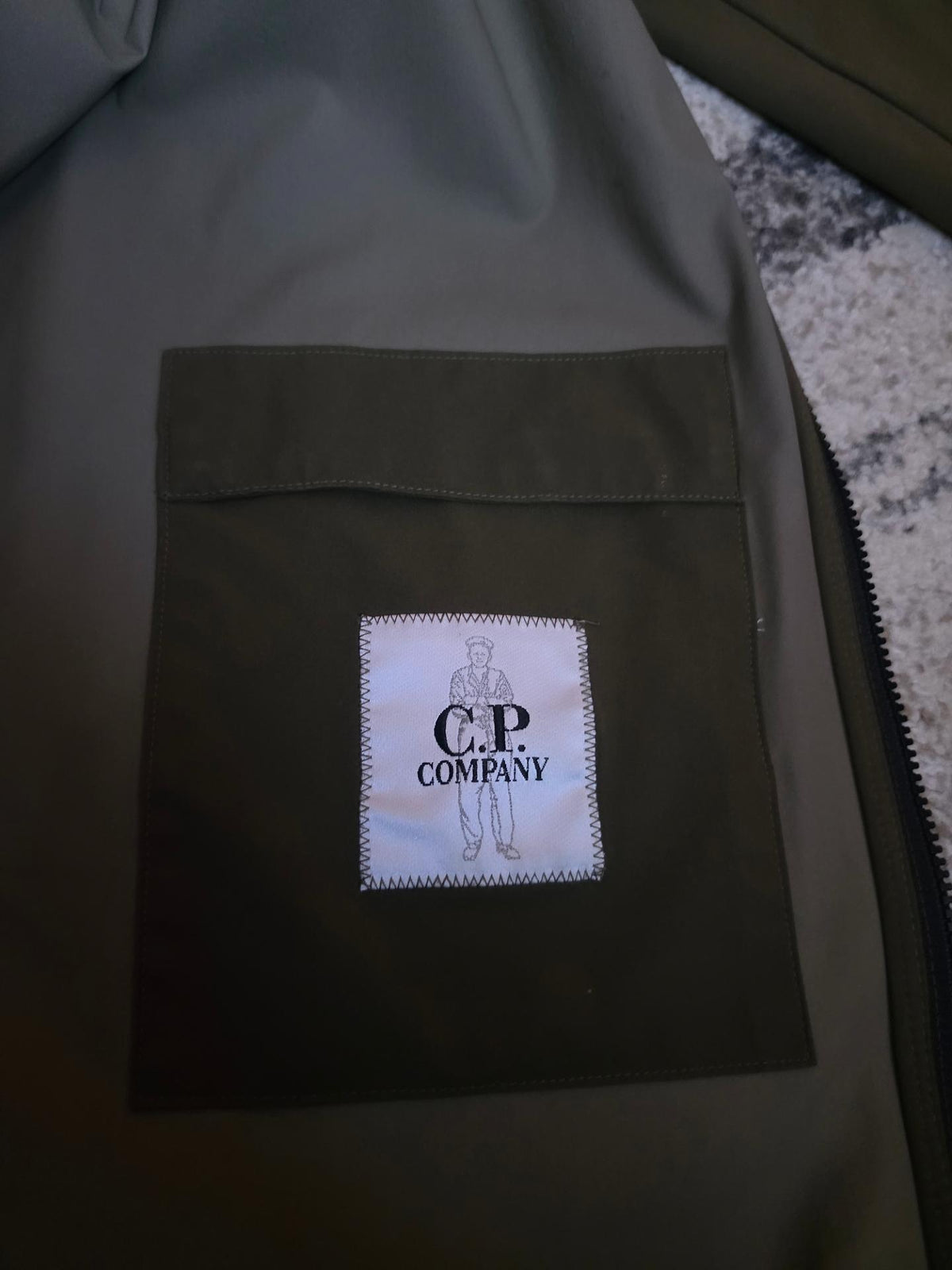 C.P. Company Pro-Tek Lens Hooded Jacket – 06CMOW019A 004117A 672 – Khaki – 56